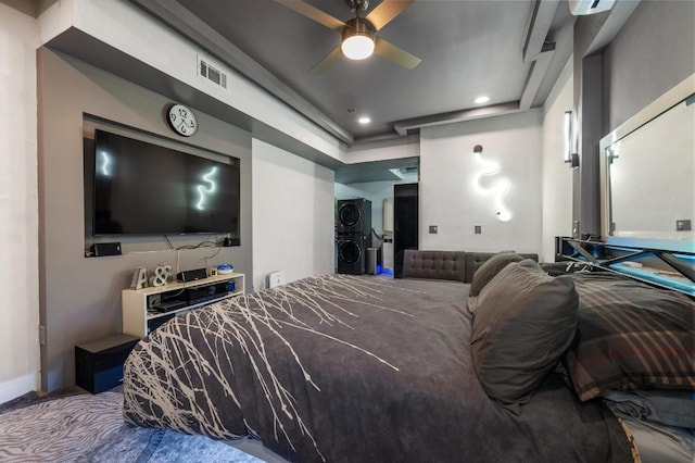 bedroom with visible vents, stacked washer / dryer, and recessed lighting
