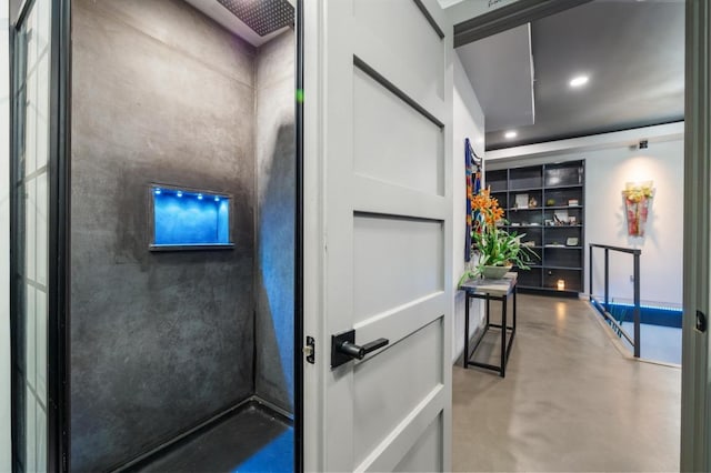 interior space with recessed lighting, concrete flooring, and built in shelves