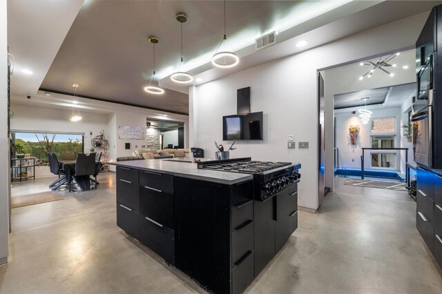 kitchen featuring black gas stovetop, dark cabinets, modern cabinets, and finished concrete flooring
