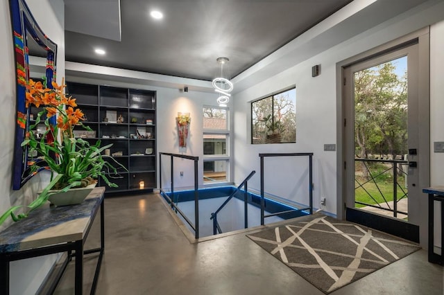 interior space with finished concrete floors, plenty of natural light, and recessed lighting