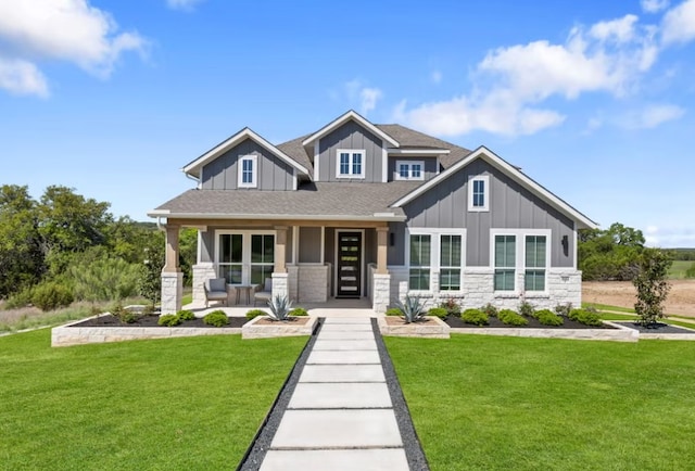 1603 Headwaters Blvd, Dripping Springs, TX 78620 - craftsman inspired home featuring a front lawn, a porch, stone siding, and board and batten siding