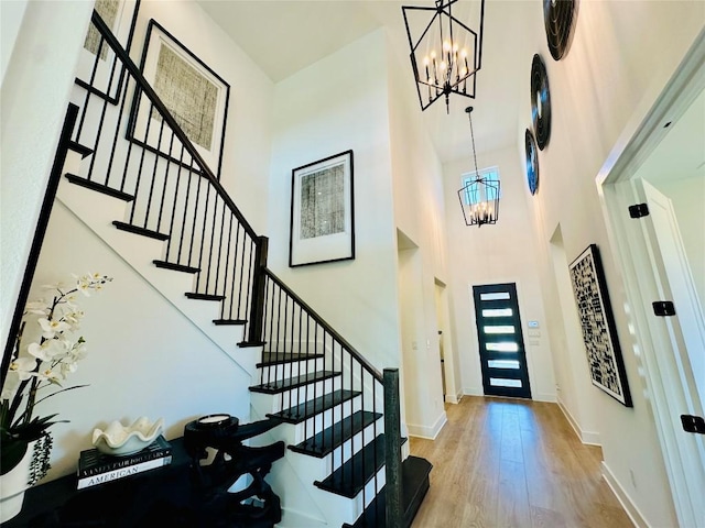 1603 Headwaters Blvd, Dripping Springs, TX 78620 - entryway featuring stairway, a high ceiling, a notable chandelier, and wood finished floors
