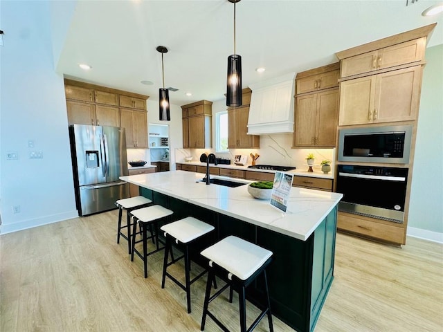 1603 Headwaters Blvd, Dripping Springs, TX 78620 - kitchen featuring custom range hood, stainless steel appliances, light wood-type flooring, and a sink