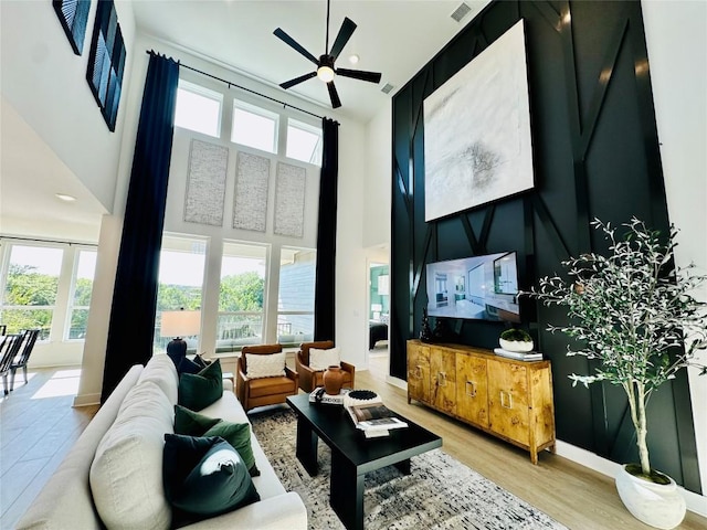1603 Headwaters Blvd, Dripping Springs, TX 78620 - living area featuring visible vents, baseboards, wood finished floors, a high ceiling, and ceiling fan