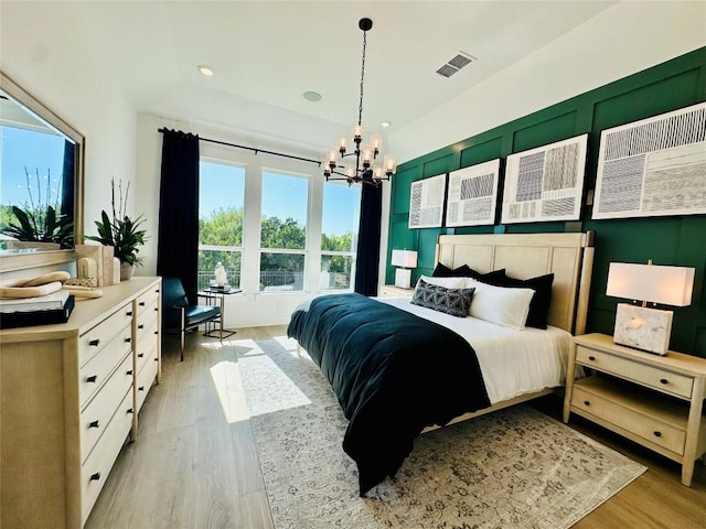 1603 Headwaters Blvd, Dripping Springs, TX 78620 - bedroom featuring light wood-style flooring, visible vents, an inviting chandelier, and recessed lighting
