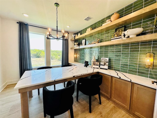 1603 Headwaters Blvd, Dripping Springs, TX 78620 - dining space featuring light wood-style flooring, baseboards, visible vents, an inviting chandelier, and recessed lighting