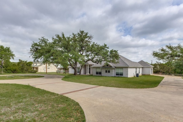 208 Saddletree Ln, Dripping Springs, TX 78620 - view of front facade featuring a front yard, concrete driveway, and cooling unit