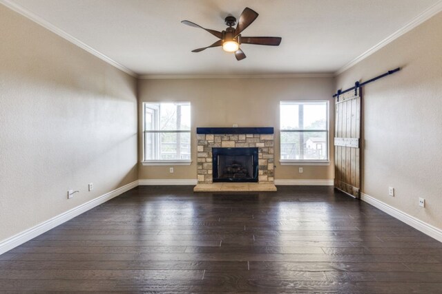 208 Saddletree Ln, Dripping Springs, TX 78620 - unfurnished living room with ceiling fan, wood-type flooring, a stone fireplace, baseboards, and crown molding