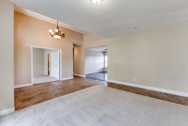 208 Saddletree Ln, Dripping Springs, TX 78620 - carpeted spare room with a chandelier, baseboards, and stone finish floors