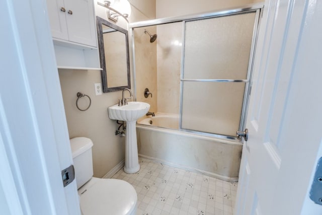 208 Saddletree Ln, Dripping Springs, TX 78620 - bathroom featuring toilet, combined bath / shower with glass door, and baseboards