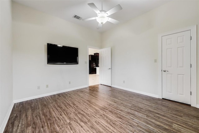 5004 Arrowhead Dr, Lago Vista, TX 78645 - spare room featuring wood finished floors, ceiling fan, and baseboards