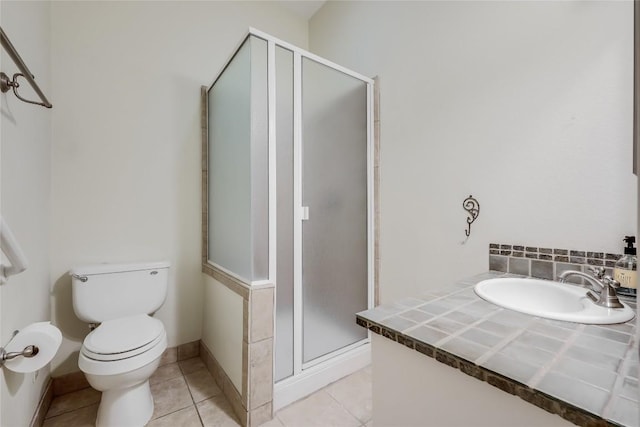5004 Arrowhead Dr, Lago Vista, TX 78645 - full bathroom with a sink, a shower stall, toilet, tile patterned flooring, and baseboards