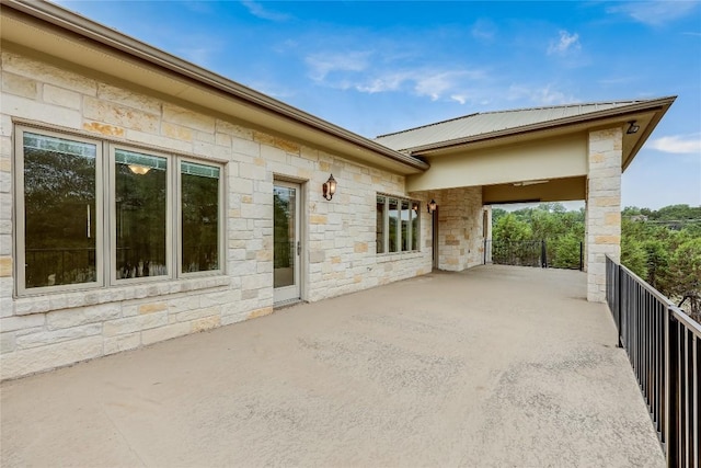 5004 Arrowhead Dr, Lago Vista, TX 78645 - view of side of home featuring stone siding and a balcony