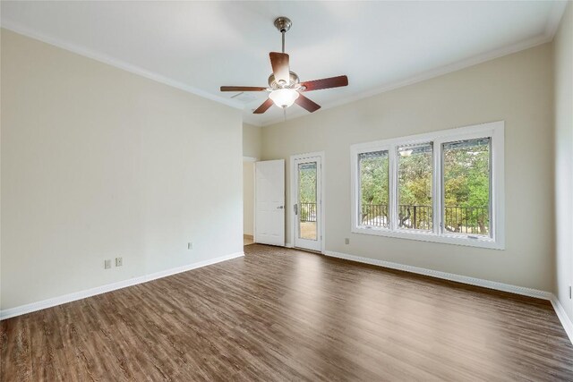 5004 Arrowhead Dr, Lago Vista, TX 78645 - empty room with dark wood-style floors, ornamental molding, baseboards, and a ceiling fan