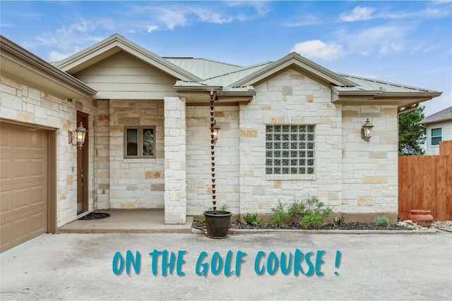 5004 Arrowhead Dr, Lago Vista, TX 78645 - view of exterior entry with stone siding, metal roof, and fence