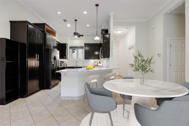 5004 Arrowhead Dr, Lago Vista, TX 78645 - kitchen featuring black fridge, tasteful backsplash, light tile patterned flooring, crown molding, and a peninsula