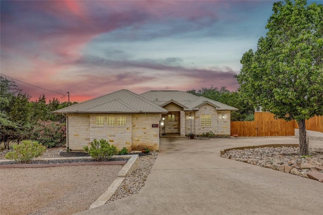5004 Arrowhead Dr, Lago Vista, TX 78645 - ranch-style home with stone siding, fence, and concrete driveway