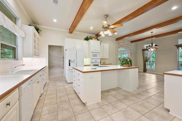 kitchen with a center island, a sink, white appliances, light tile patterned floors, and visible vents