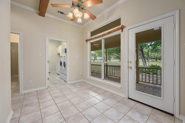 empty room featuring visible vents, crown molding, light tile patterned floors, and washer and clothes dryer