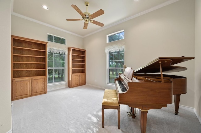 living area featuring visible vents, carpet floors, crown molding, baseboards, and ceiling fan