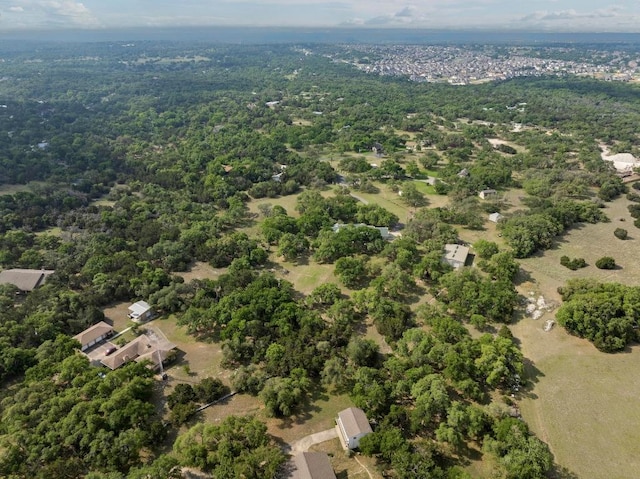 bird's eye view with a wooded view