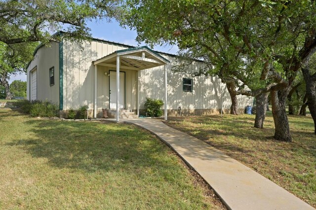 view of front facade with a front lawn and board and batten siding