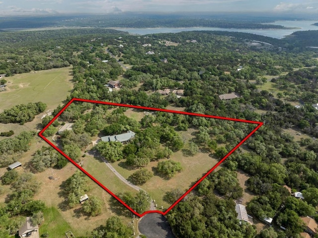 bird's eye view with a wooded view