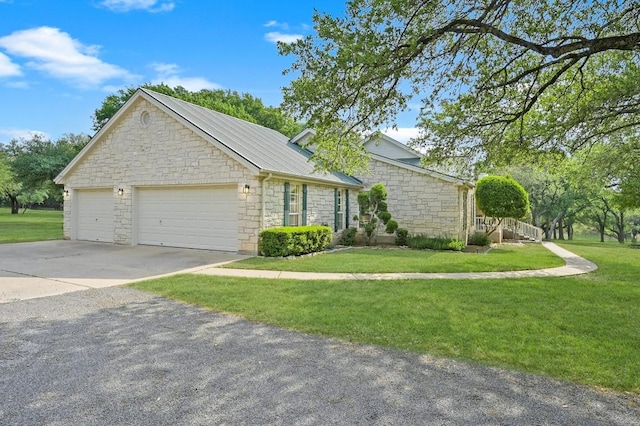 view of front facade with stone siding, a front lawn, and a garage