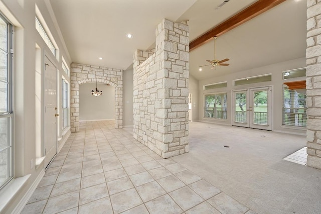 hall featuring high vaulted ceiling, french doors, beamed ceiling, carpet flooring, and ornate columns
