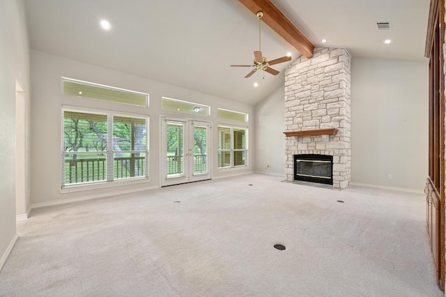 unfurnished living room with carpet flooring, beam ceiling, visible vents, ceiling fan, and a fireplace