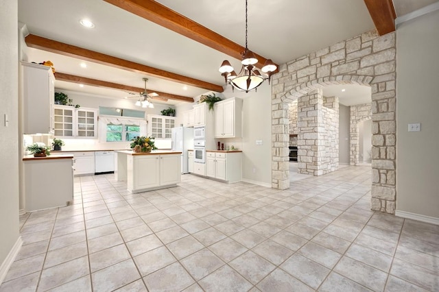 kitchen with white cabinets, ceiling fan with notable chandelier, beamed ceiling, white appliances, and light countertops