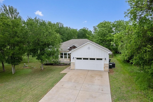 ranch-style house with a front lawn, a garage, driveway, stone siding, and board and batten siding