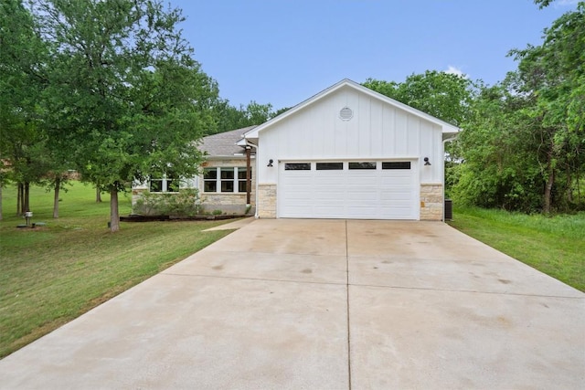 ranch-style home featuring board and batten siding, a front yard, an attached garage, and stone siding