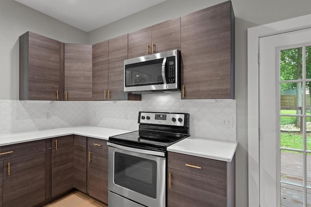 kitchen with appliances with stainless steel finishes, tasteful backsplash, light countertops, and dark brown cabinetry