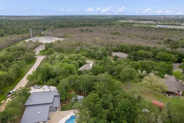 birds eye view of property featuring a view of trees