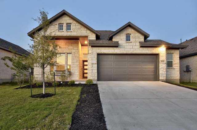 view of front of property featuring concrete driveway, a front lawn, stone siding, a shingled roof, and a garage