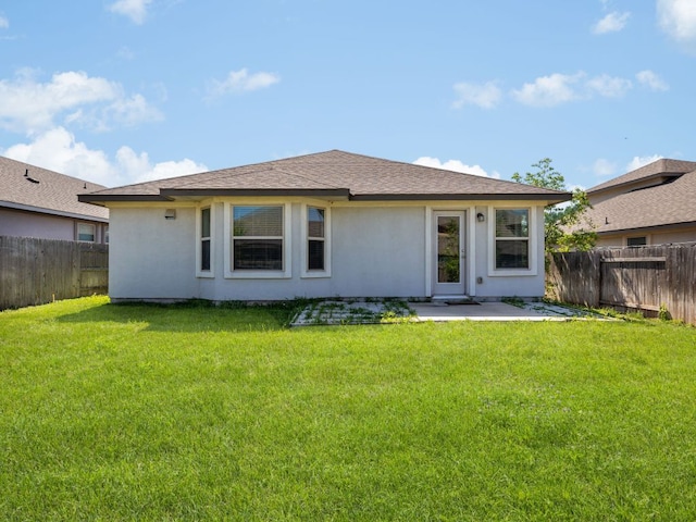 180 Tailwind Dr, Kyle, TX 78640 - rear view of property featuring a fenced backyard, a patio area, and stucco siding