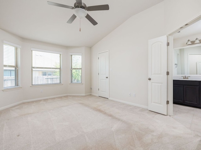 180 Tailwind Dr, Kyle, TX 78640 - unfurnished bedroom featuring lofted ceiling, light carpet, ensuite bath, and a ceiling fan