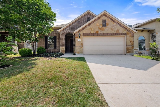535 Tranquility Mtn, Buda, TX 78610 - view of front of home featuring stone siding, a garage, concrete driveway, a front lawn, and brick siding