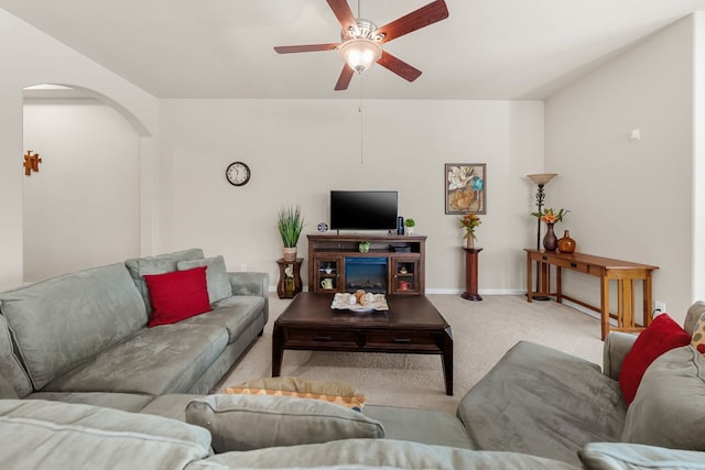 535 Tranquility Mtn, Buda, TX 78610 - carpeted living room featuring a ceiling fan, arched walkways, and baseboards