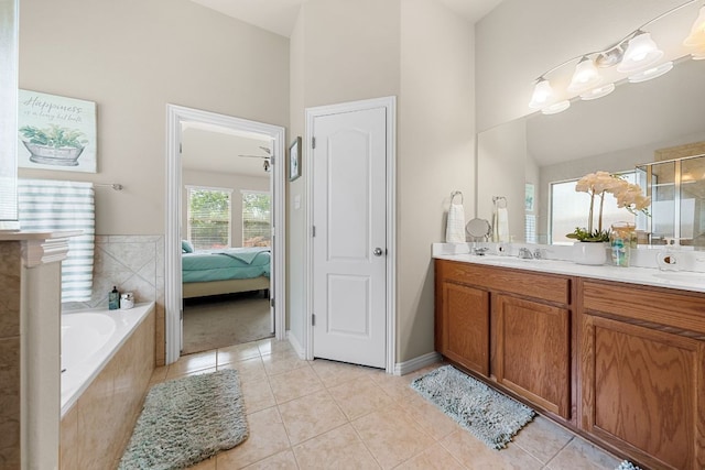 535 Tranquility Mtn, Buda, TX 78610 - bathroom with double vanity, a garden tub, tile patterned floors, and a shower with door