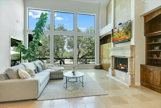 5711 Pool Canyon Cv, Austin, TX 78734 - living room with a towering ceiling, a premium fireplace, healthy amount of natural light, ornamental molding, and baseboards
