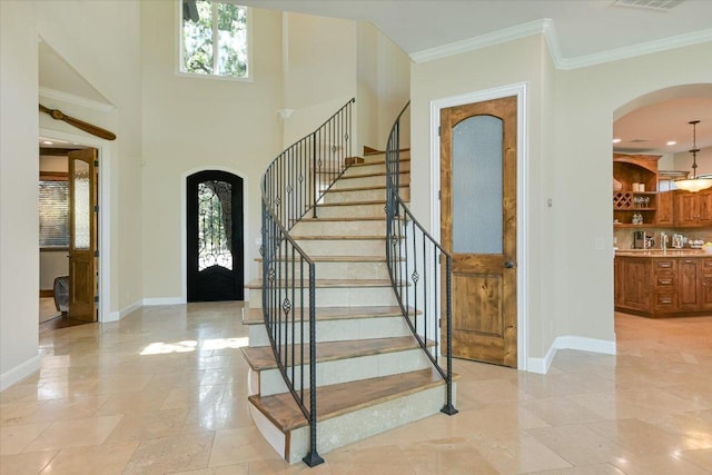 5711 Pool Canyon Cv, Austin, TX 78734 - foyer entrance featuring arched walkways, baseboards, stairway, and crown molding