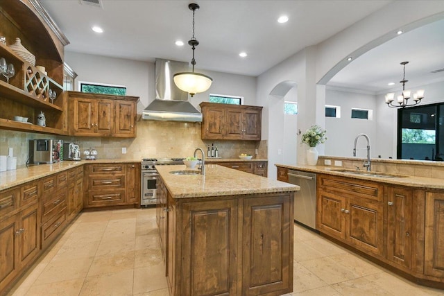5711 Pool Canyon Cv, Austin, TX 78734 - kitchen featuring wall chimney exhaust hood, appliances with stainless steel finishes, a sink, arched walkways, and tasteful backsplash