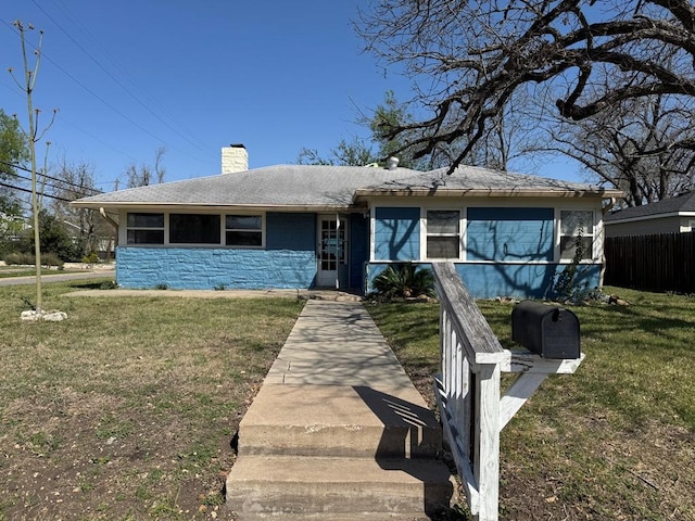 1120 Fisher St, Taylor, TX 76574 - view of front facade featuring a chimney and stone siding