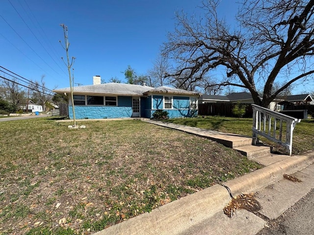 view of front of home featuring a front yard and a chimney