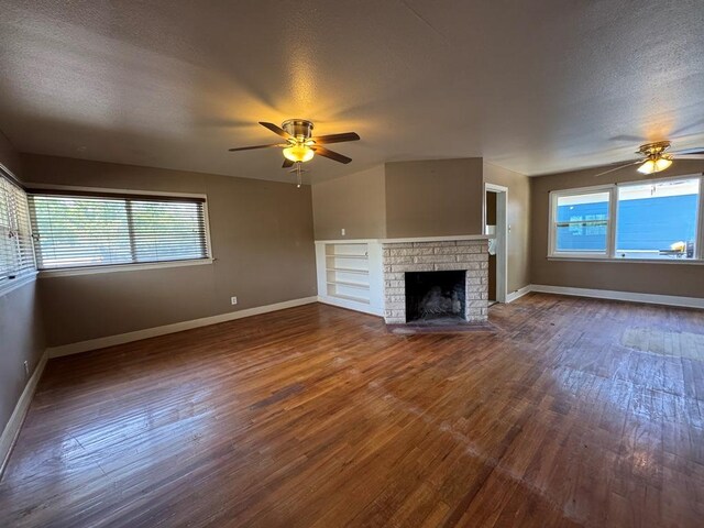 1120 Fisher St, Taylor, TX 76574 - unfurnished living room with ceiling fan, wood finished floors, healthy amount of natural light, and a textured ceiling