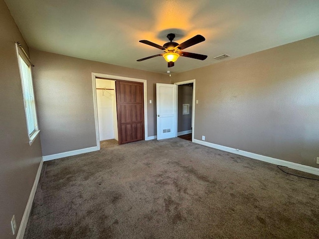unfurnished bedroom featuring visible vents, a ceiling fan, a closet, baseboards, and carpet flooring