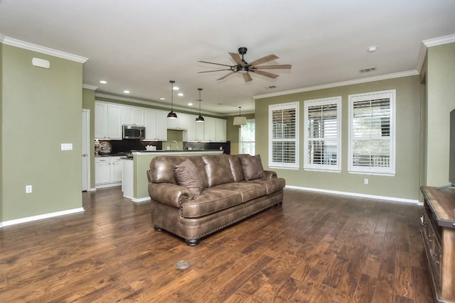 802 Apache Mountain Ln, Georgetown, TX 78633 - living area with ceiling fan, crown molding, dark wood-type flooring, baseboards, and recessed lighting