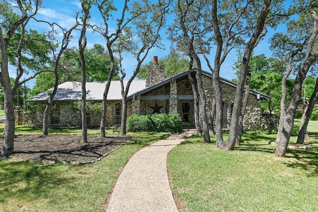 9401 Cedar Crest Dr, Austin, TX 78750 - view of front of home with stone siding, a chimney, and a front yard